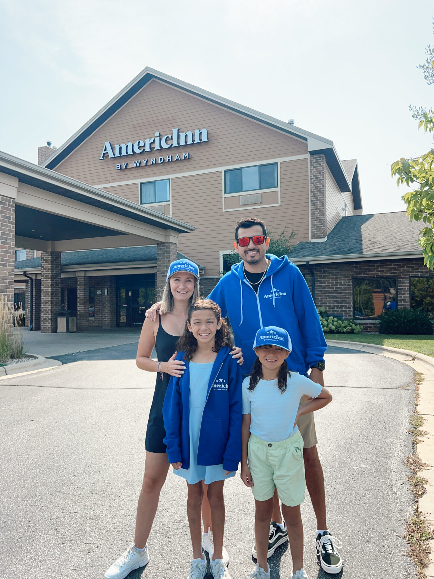 family in front of hotel